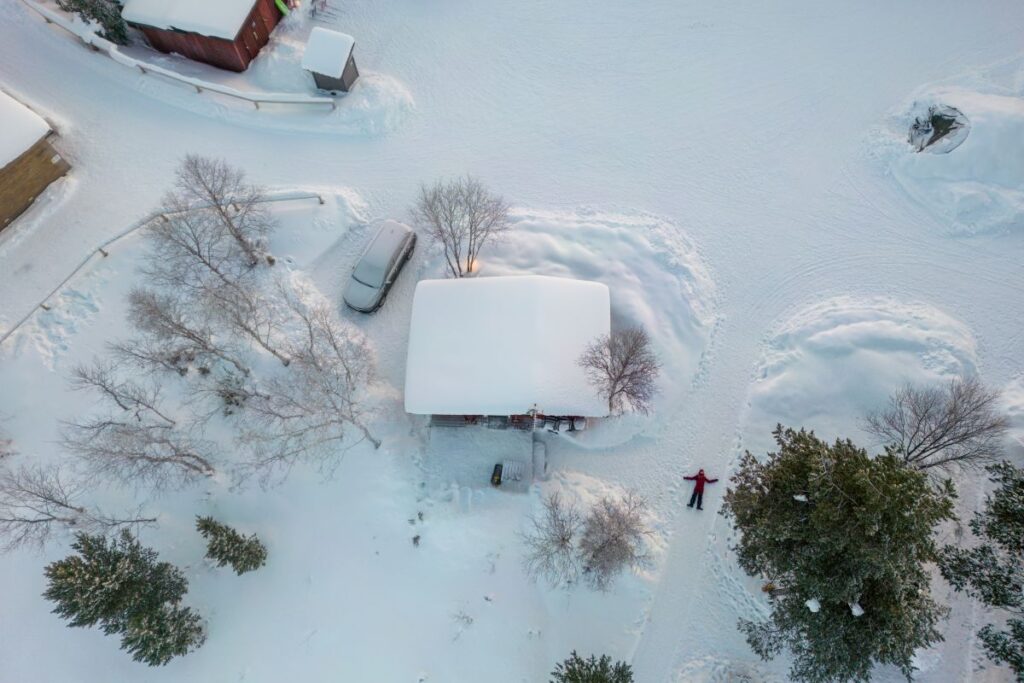 Close-up of roof drain being checked for debris