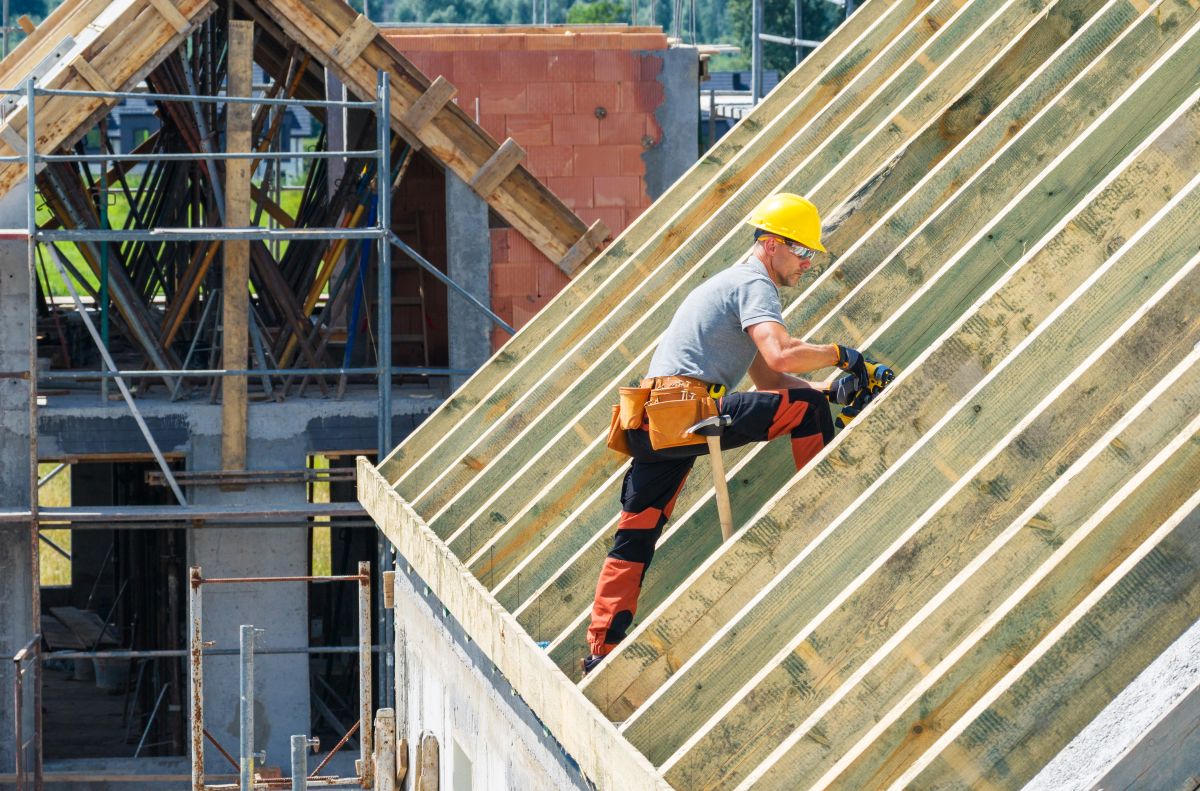 Calgary roofing contractor inspecting hail-damaged shingles after summer storm