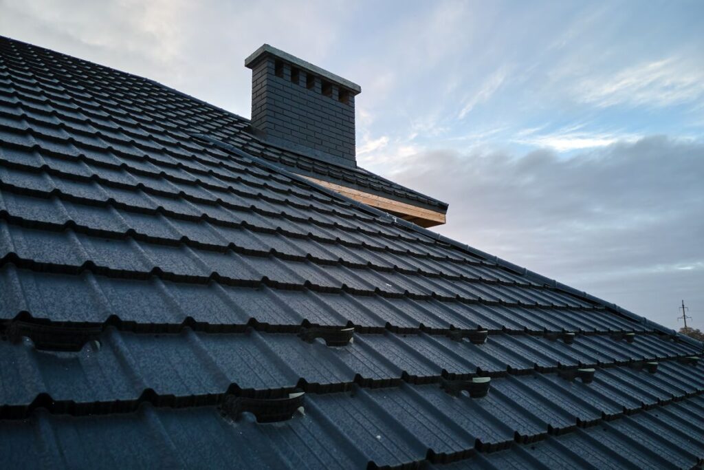Calgary homeowner inspecting curling and cracked shingles on residential roof